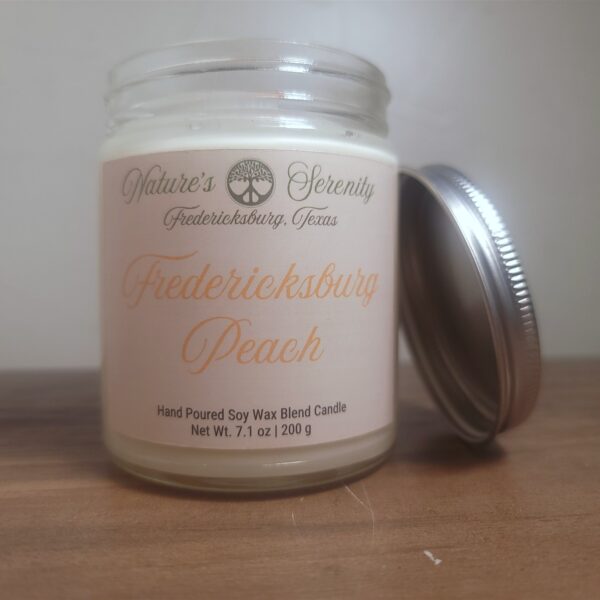 Open Fredericksburg Peach soy wax blend candle with wooden wick and metal lid